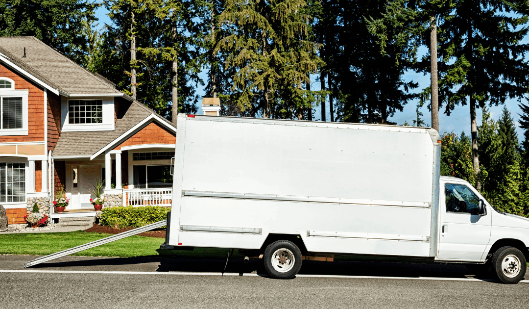 Moving truck parked outside a Virginia Beach home with a Sold sign, symbolizing a fast cash home sale during relocation.